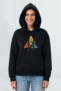 Person wearing a black hoodie with a colorful triangle design on a light background