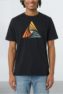 Person wearing a black t-shirt with a colorful triangle design on a plain background