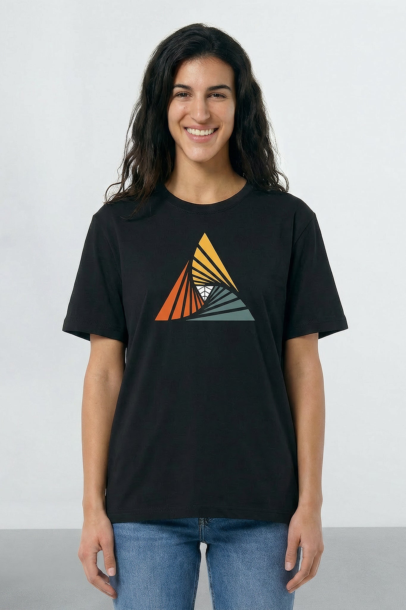 Person wearing a black t-shirt with a colorful triangle design on a plain background