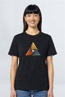 Person wearing a black t-shirt with a colorful triangle design on a plain background