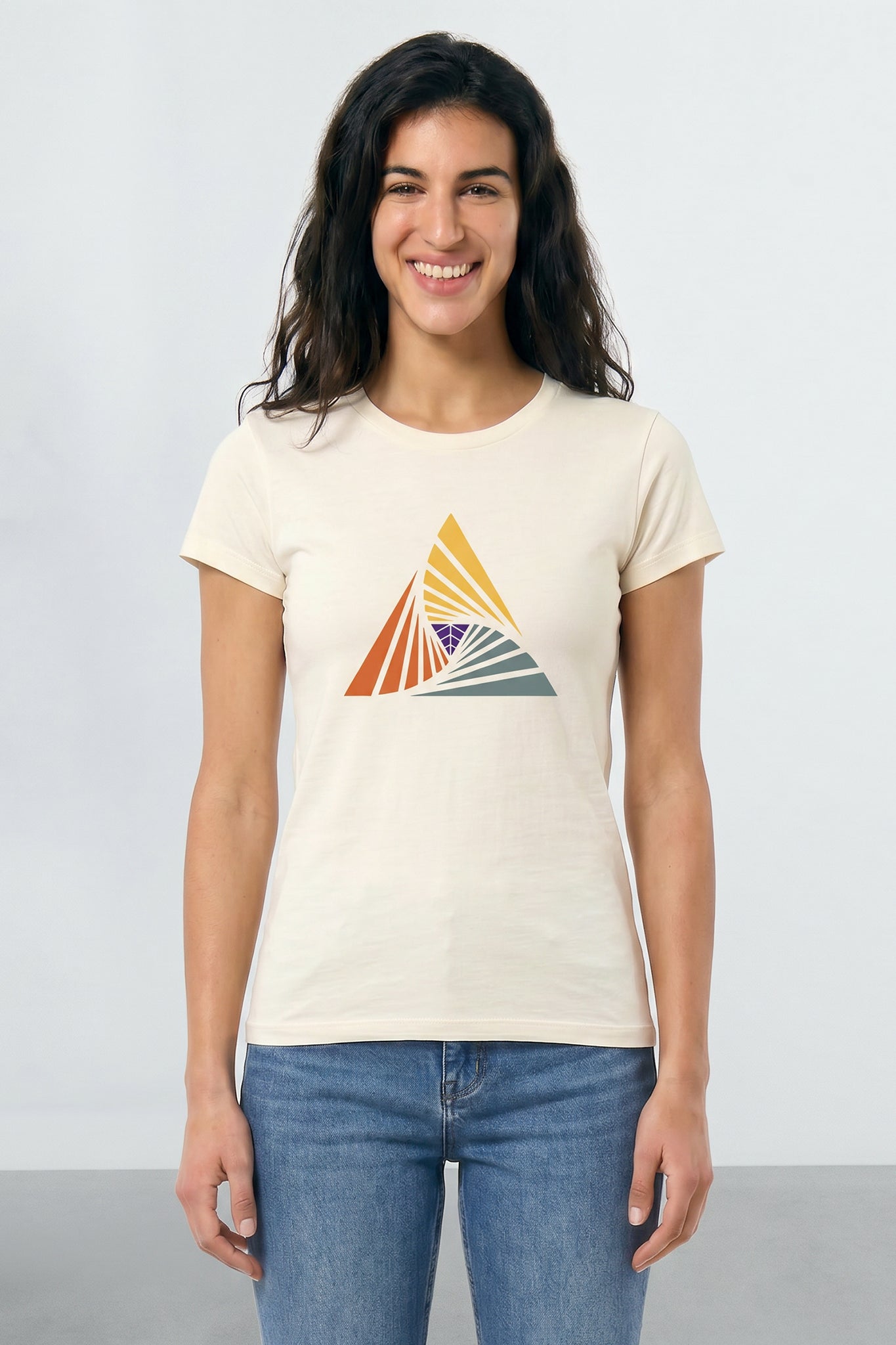 Woman wearing a beige t-shirt with a colorful triangle design on a plain background