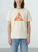 Person wearing a beige t-shirt with an orange geometric design on a plain background