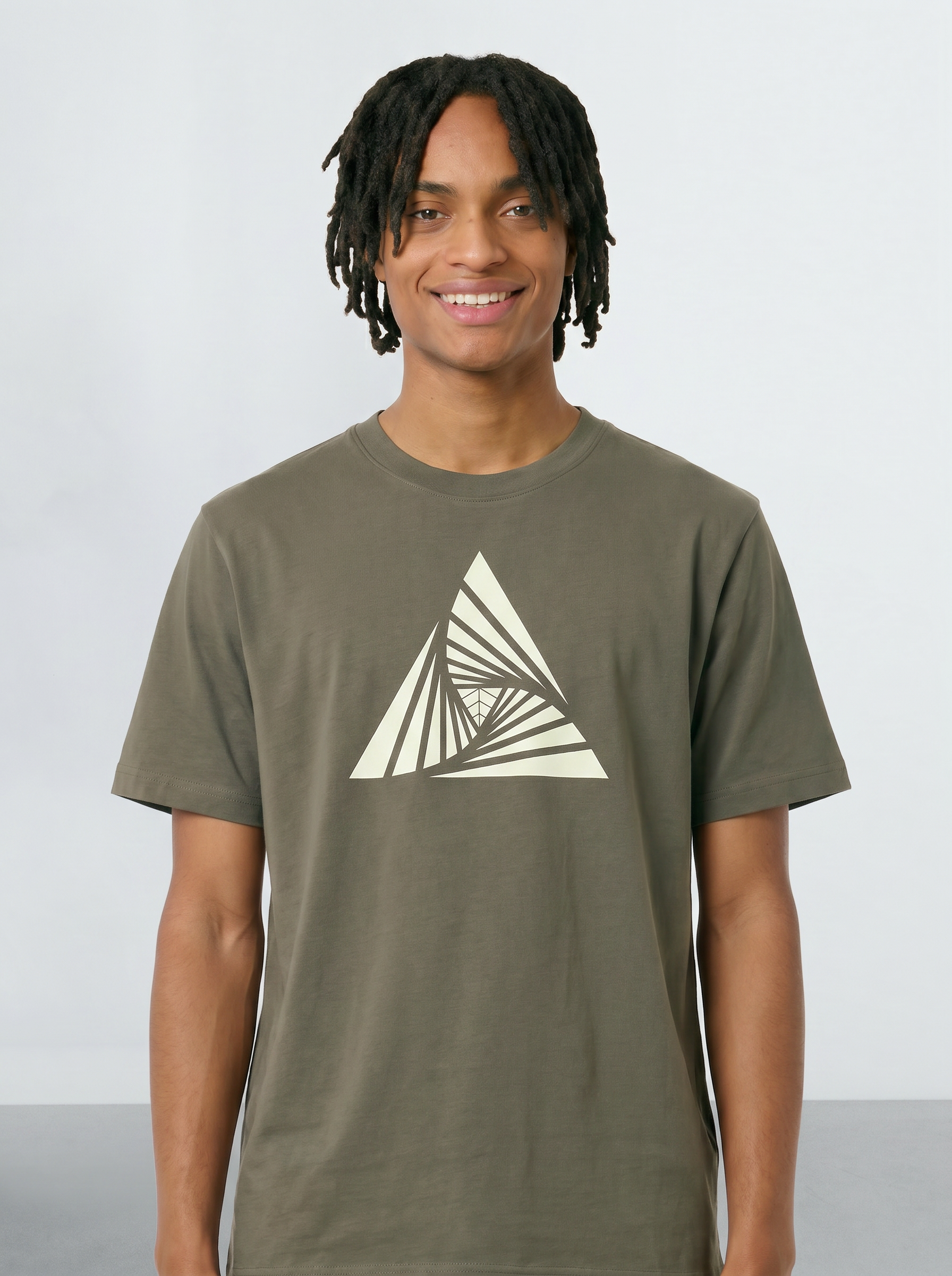 Person wearing a Khaki green t-shirt with a geometric triangle design on a plain background